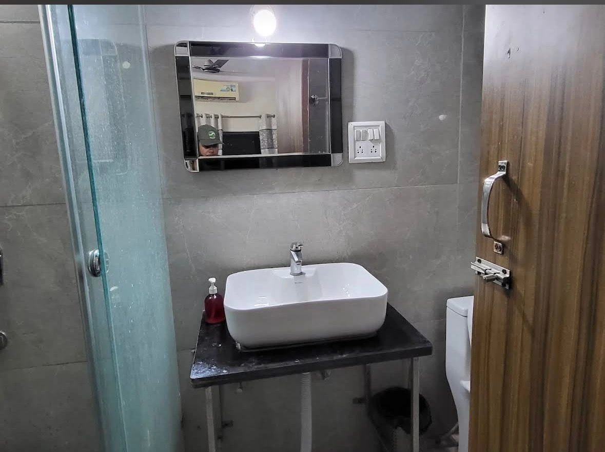 Clean modern bathroom in Haridwar hotel with shower, washbasin and premium fittings